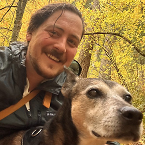 Vet doing a wellness exam on a little dog.
